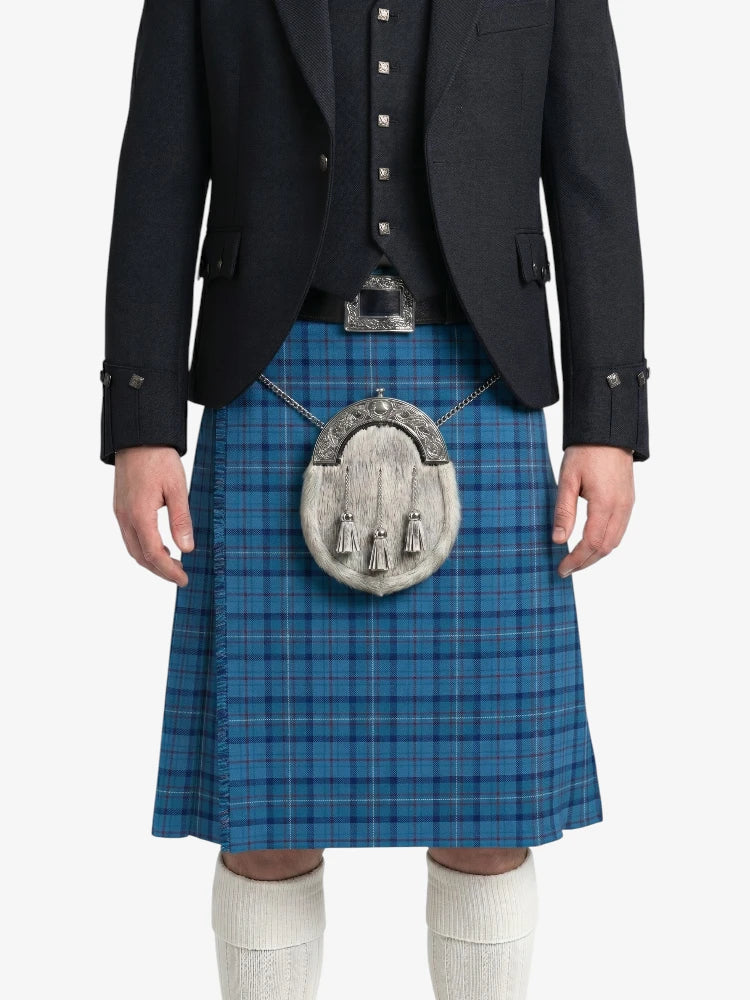 Person wearing a blue plaid kilt with a black jacket on a white background
