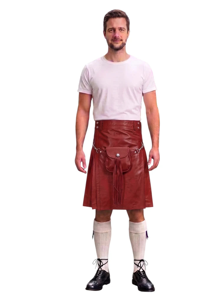 A man modeling a dark red leather kilt with a front pouch pocket, paired with a white t-shirt, cream knee-high socks, and black lace-up shoes, against a plain white background.