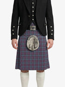Person wearing a traditional Scottish kilt with a jacket on a white background