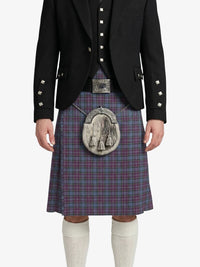 Person wearing a traditional Scottish kilt with a jacket on a white background