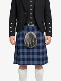 Person wearing a black jacket, blue plaid kilt, and white socks on a white background