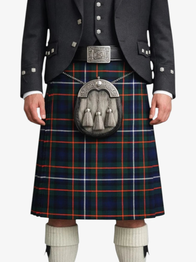 Person wearing a Scottish kilt with a tartan pattern on a white background