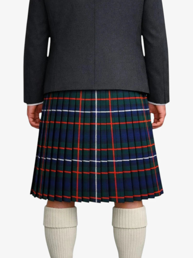 Person wearing a black jacket and a plaid kilt with white socks on a white background