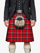 Person wearing a red tartan kilt with a black jacket and white knee-high socks on a white background