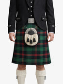 Person wearing a traditional Scottish kilt with a tartan pattern on a white background