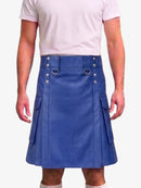 A man wearing a blue faux-leather kilt with silver-tone metal hardware and side cargo pockets, paired with a light pink t-shirt and white socks, against a plain white background.