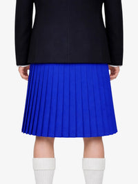 Person wearing a black jacket and blue pleated kilt on a white background