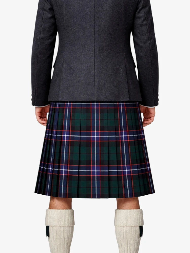 Person wearing a dark jacket and plaid kilt on a white background