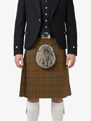 Traditional Scottish kilt with a dark jacket and white socks on a white background