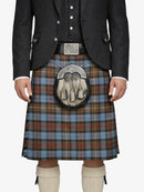 Person wearing a traditional Scottish kilt with a tartan pattern on a white background