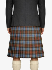 Person wearing a dark gray coat and plaid kilt on a white background