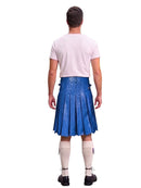 A man shown from the back wearing a blue leather kilt, a light pink t-shirt, cream knee-high socks, and black shoes, isolated on a white background.