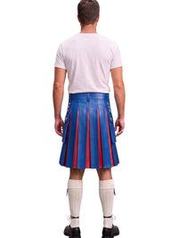 A man viewed from behind wearing a blue leather kilt with red pleated stripes, a white t-shirt, white knee-high socks, and black shoes, against a plain white background.