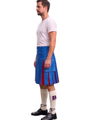 A man shown in profile wearing a blue leather kilt with red pleated side panels, a white t-shirt, cream knee-high socks, and black shoes, against a plain white background.