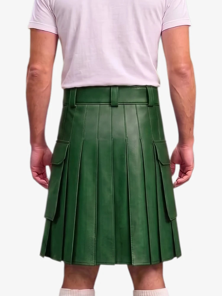 A person shown from the back wearing a dark green pleated leather kilt with side cargo pockets, paired with a light pink t-shirt and white socks, against a plain light gray background.