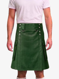 A man wearing a dark green faux-leather kilt with silver-tone metal hardware and side pockets, paired with a light pink t-shirt and white socks, shown against a plain white background.