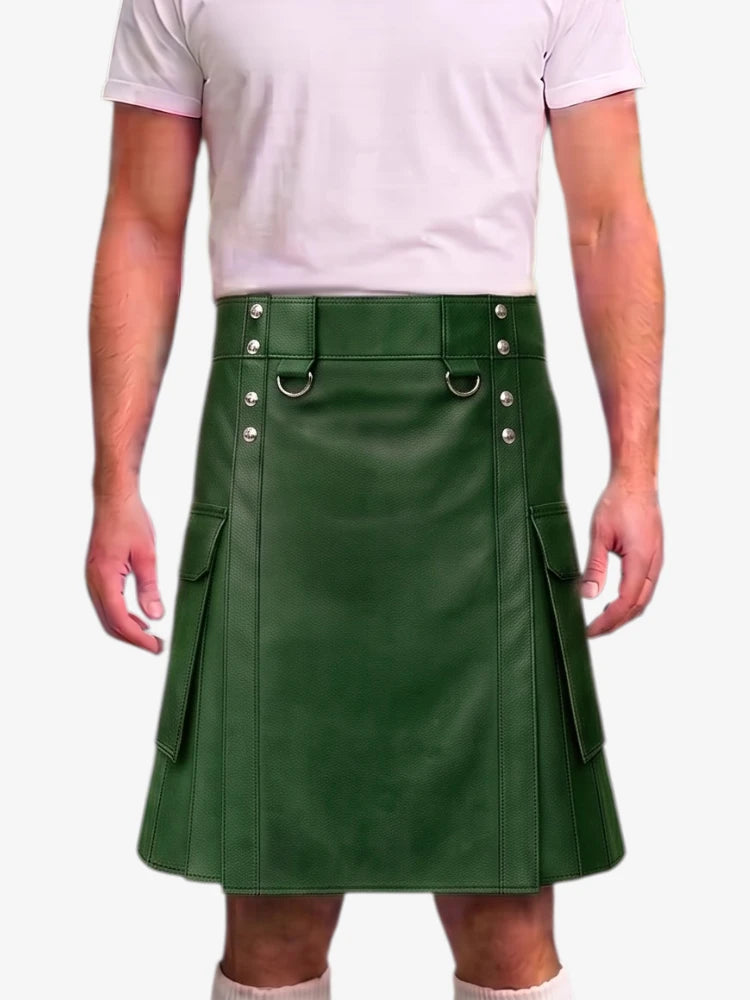 A man wearing a dark green faux-leather kilt with silver-tone metal hardware and side pockets, paired with a light pink t-shirt and white socks, shown against a plain white background.