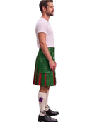 A man shown in profile wearing a green kilt with red and white striped pleats, a white t-shirt, white socks, and black shoes, against a plain white background.