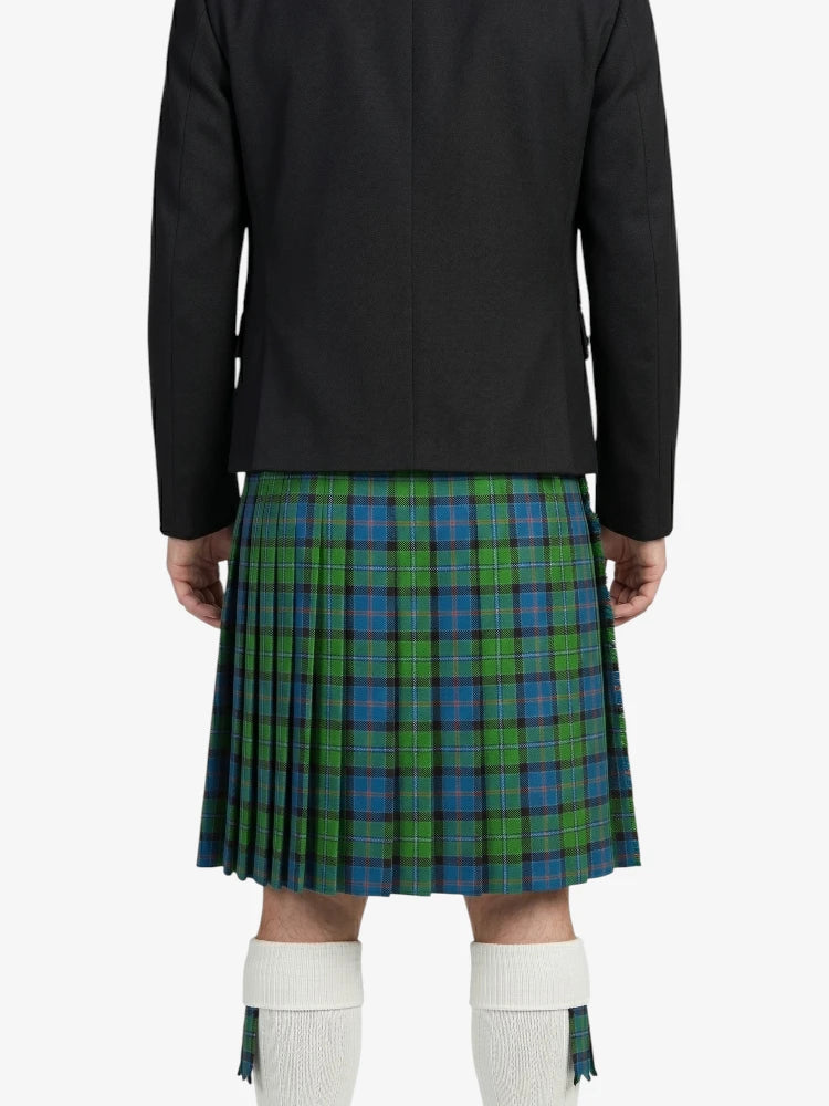 Person wearing a black jacket and green plaid kilt on a white background