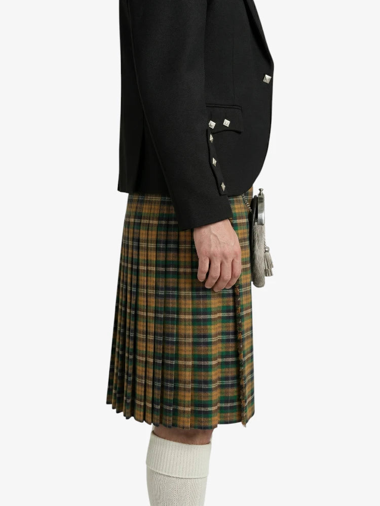 Person wearing a black jacket and green plaid kilt on a white background