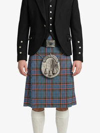 Person wearing a traditional Scottish kilt with a black jacket on a white background