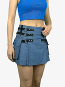 Person wearing a blue skirt with black belt and hardware on a white background