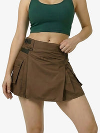 Woman wearing a green crop top and brown cargo skirt on a white background