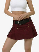 Person wearing a white crop top and maroon skirt with gold buttons on a white background