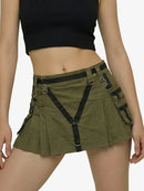 Person wearing a green skirt with black suspenders on a white background