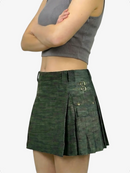 Green pleated skirt worn by a person on a white background