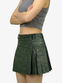 Green pleated skirt worn by a person on a white background