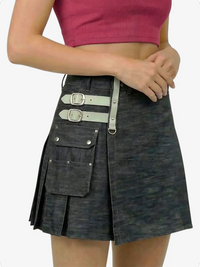 Black denim kilt with silver buckles worn by a person on a white background