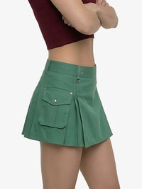 Green pleated skirt worn by a person on a white background