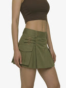Person wearing a green skirt with belt and pockets on a white background