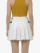 White pleated skirt worn by a person on a white background