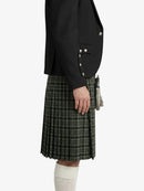Person wearing a black blazer and plaid kilt on a white background