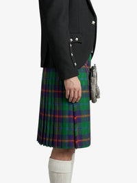 Person wearing a black jacket and green plaid kilt on a white background
